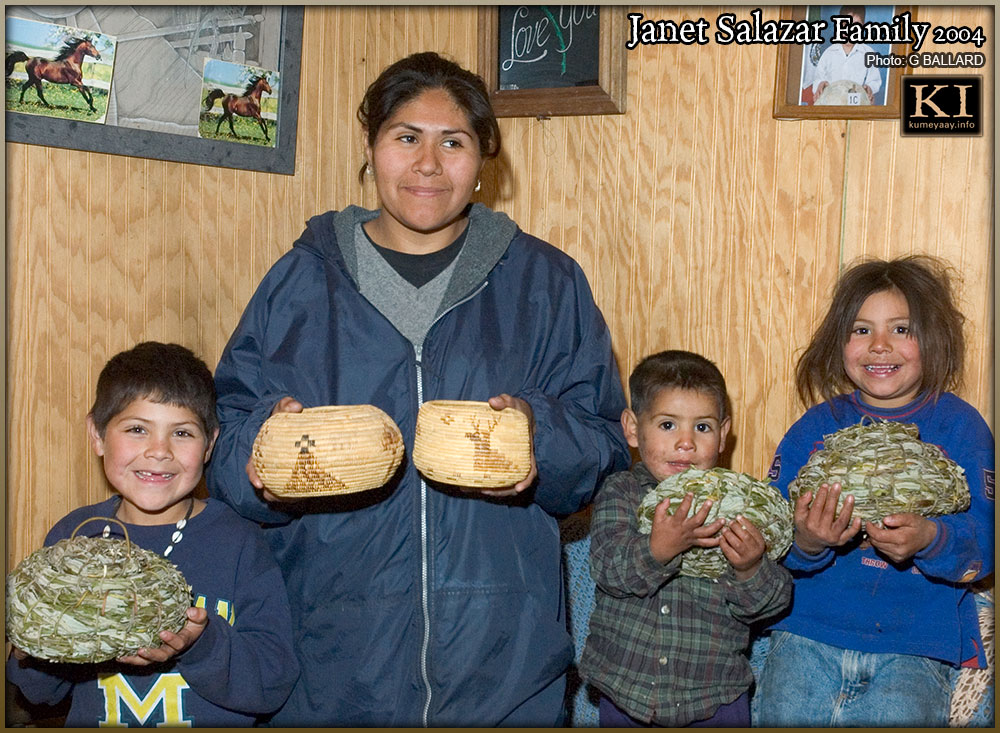 Indigenous woman with children holding basket art objects