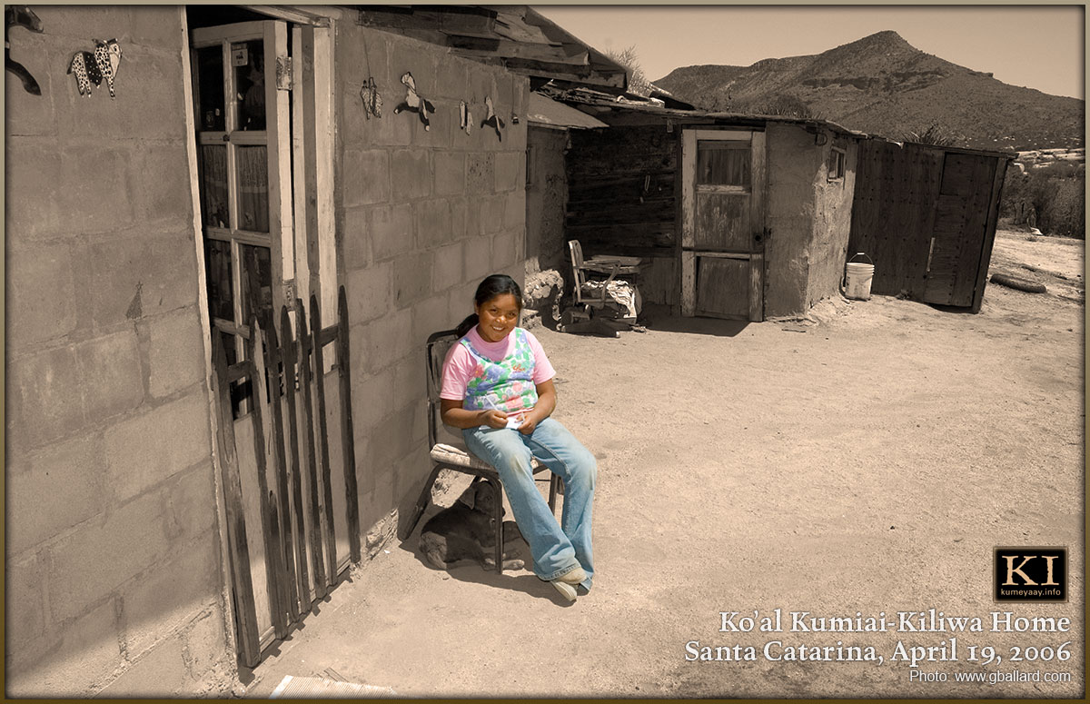 Young Kumiai-Kiliwa girl sites in fron of her family ranch home in Santa Catarinl